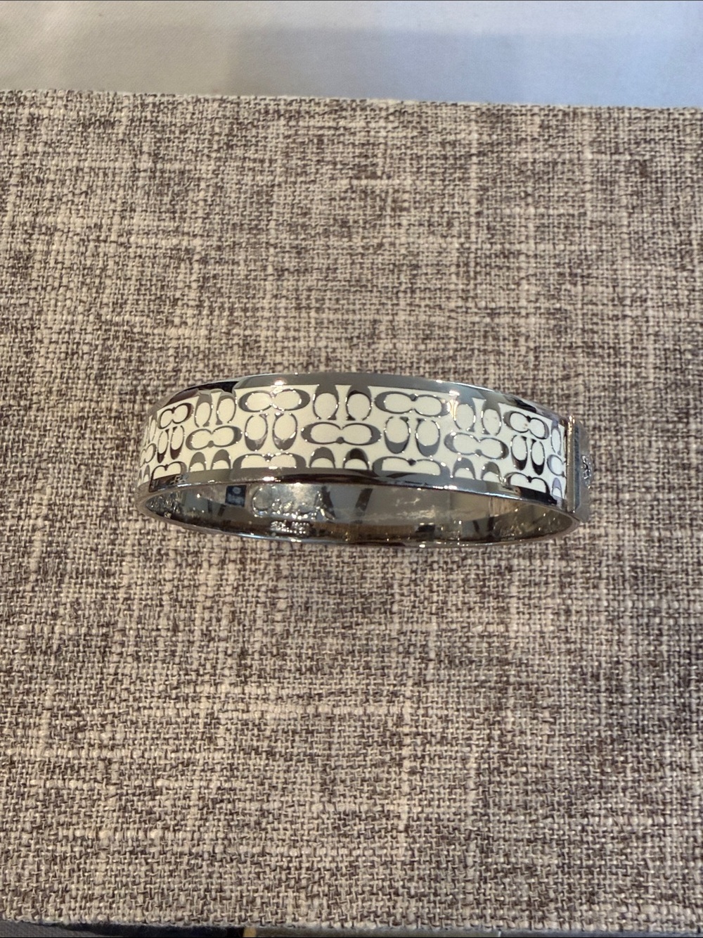 Coach Silver-Tone Bangle with White Enamel Signature Pattern